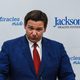 Image for article titled Watch: Brave Soul Interrupts Dumbass Florida Governor Who Just Stands There Like an Idiot